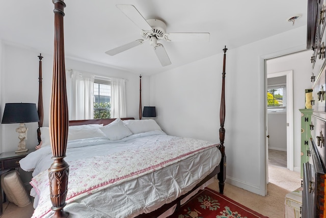 bedroom with ceiling fan, baseboards, and carpet