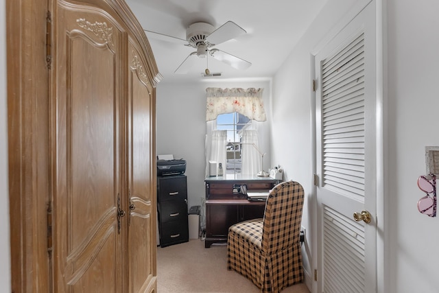 office area featuring ceiling fan, visible vents, and light carpet