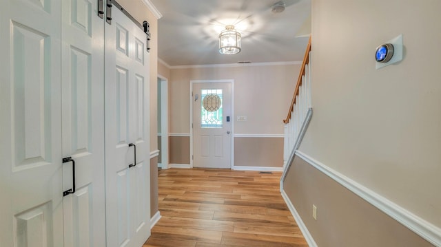13 Mooring Cir, Seaville, NJ 08230 - entryway featuring light wood-style floors, a barn door, stairway, and crown molding