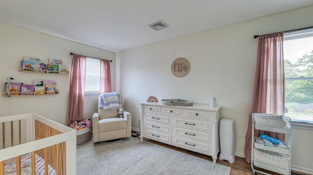 13 Mooring Cir, Seaville, NJ 08230 - bedroom with multiple windows, a nursery area, and light wood finished floors