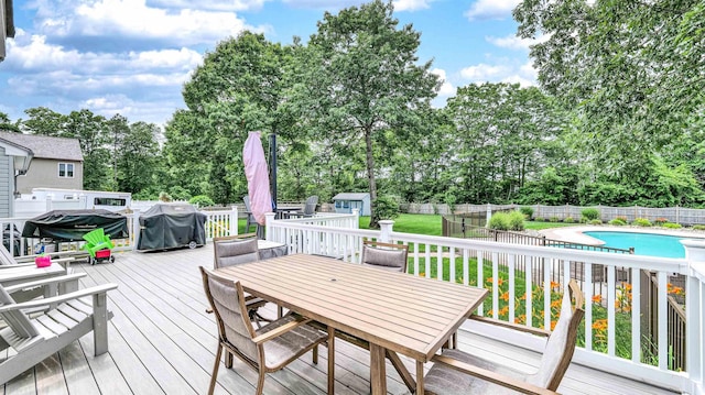 13 Mooring Cir, Seaville, NJ 08230 - deck with outdoor dining space, a shed, a fenced backyard, view of wooded area, and grilling area