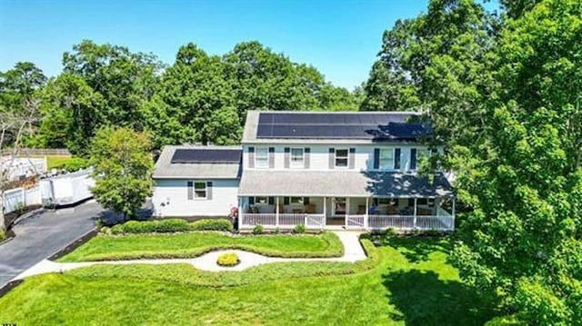 13 Mooring Cir, Seaville, NJ 08230 - view of front of home featuring a porch, a front lawn, and solar panels