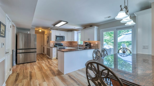 13 Mooring Cir, Seaville, NJ 08230 - kitchen with appliances with stainless steel finishes, white cabinets, a peninsula, light wood-type flooring, and ornamental molding
