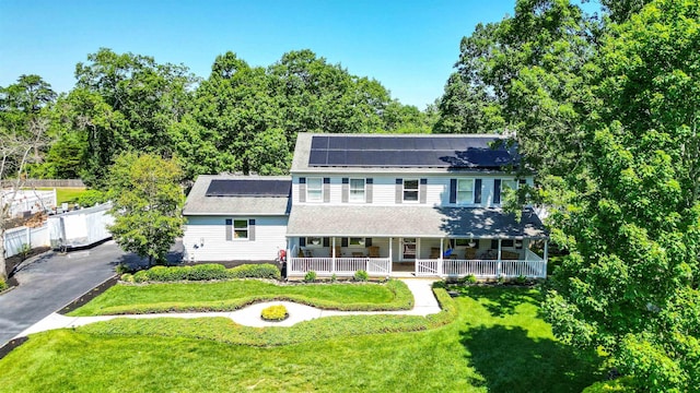 13 Mooring Cir, Seaville, NJ 08230 - view of front of home featuring a porch, roof mounted solar panels, and a shingled roof