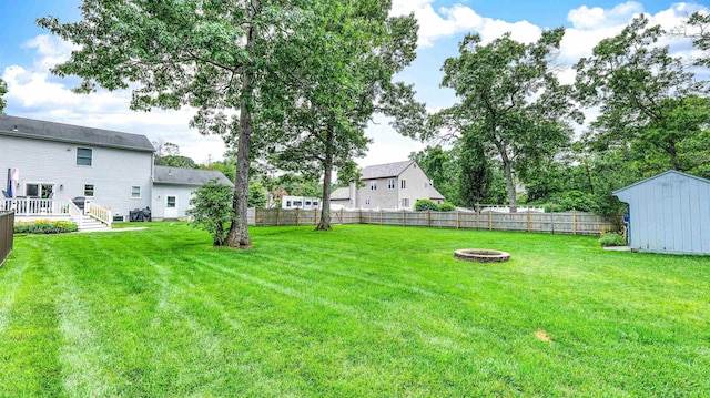13 Mooring Cir, Seaville, NJ 08230 - fenced backyard featuring an outdoor fire pit, a storage shed, and a deck