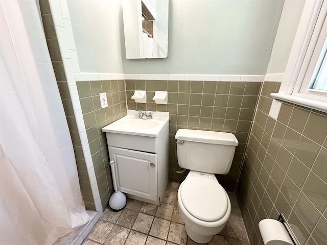 49 Hope Corson Rd, Ocean View, NJ 08230 - bathroom featuring toilet, vanity, tile walls, curtained shower, and a wainscoted wall