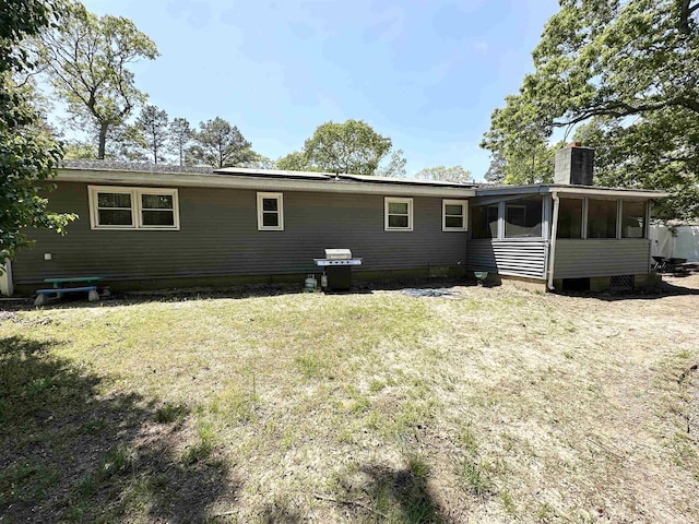 49 Hope Corson Rd, Ocean View, NJ 08230 - back of property featuring a sunroom, a chimney, and a yard