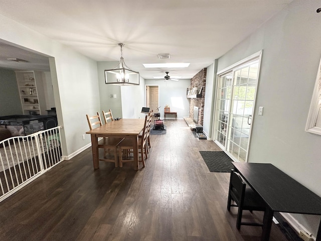 49 Hope Corson Rd, Ocean View, NJ 08230 - dining area featuring dark wood-style flooring, a ceiling fan, a stone fireplace, and baseboards