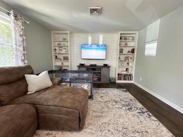 49 Hope Corson Rd, Ocean View, NJ 08230 - living area with dark wood-style floors, baseboards, lofted ceiling, a fireplace, and built in features