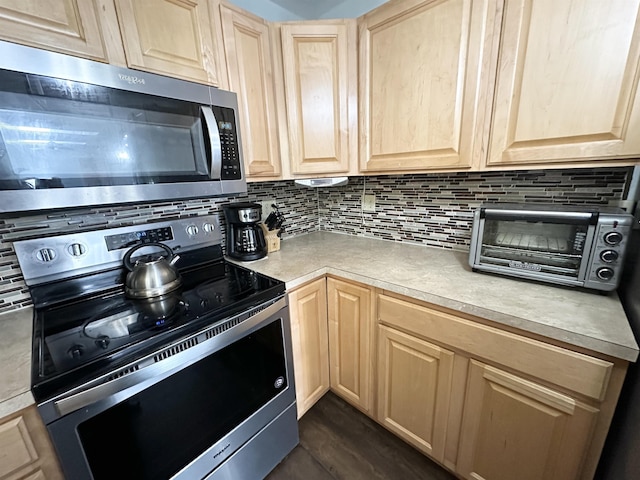 49 Hope Corson Rd, Ocean View, NJ 08230 - kitchen with stainless steel appliances, light brown cabinetry, and decorative backsplash