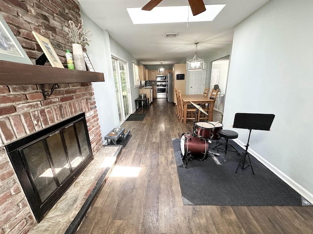 49 Hope Corson Rd, Ocean View, NJ 08230 - living room featuring a skylight, a brick fireplace, dark wood finished floors, and baseboards