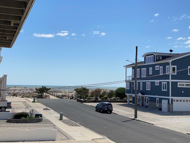 25 81st St W, Unit West, Sea Isle City, NJ 08243 - view of road with street lights, a water view, sidewalks, and curbs