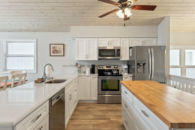 25 81st St W, Unit West, Sea Isle City, NJ 08243 - kitchen with a sink, butcher block countertops, stainless steel appliances, a peninsula, and a wealth of natural light