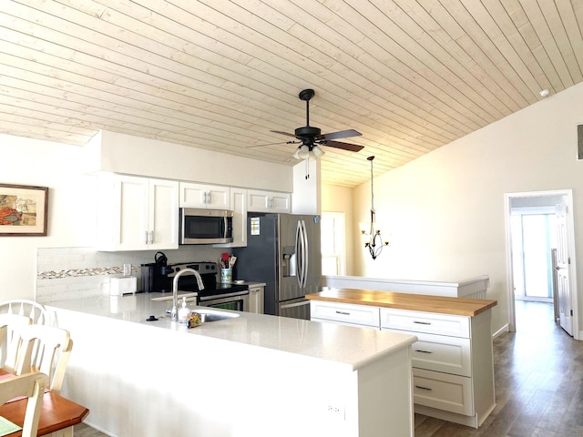 25 81st St W, Unit West, Sea Isle City, NJ 08243 - kitchen with stainless steel appliances, wood ceiling, ceiling fan with notable chandelier, and a peninsula