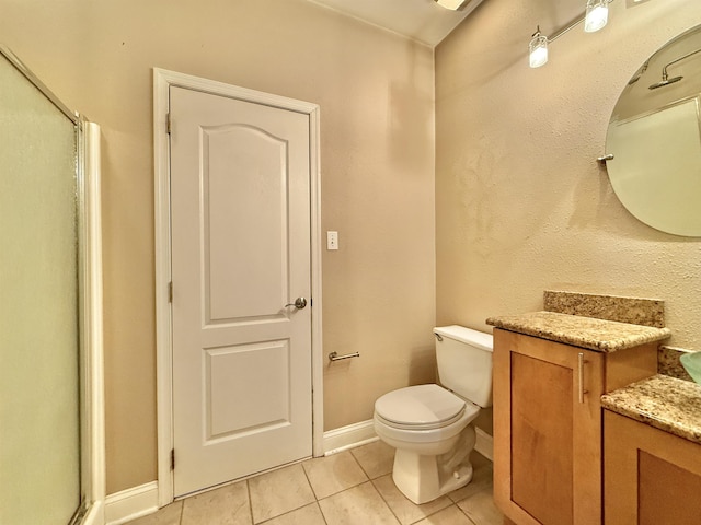 bathroom with tile patterned flooring, vanity, toilet, and an enclosed shower