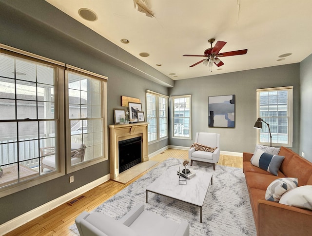 living room with ceiling fan and light wood-type flooring