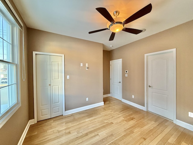 unfurnished bedroom with ceiling fan and light hardwood / wood-style flooring