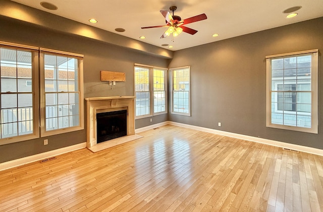 unfurnished living room featuring light hardwood / wood-style flooring and ceiling fan