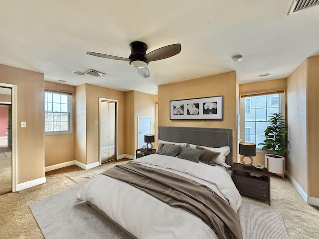 bedroom featuring light colored carpet and ceiling fan