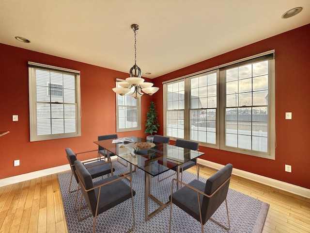 dining space featuring a notable chandelier and light hardwood / wood-style flooring