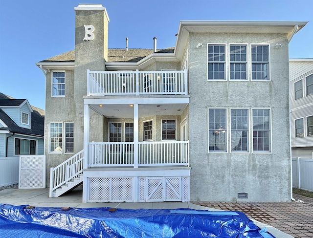 back of property featuring a covered pool