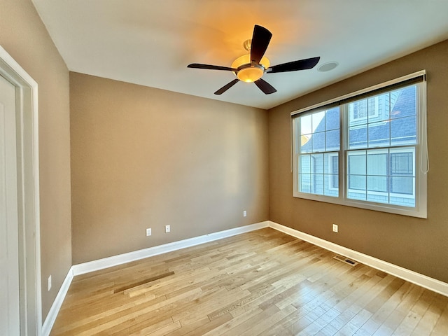 spare room featuring ceiling fan and light hardwood / wood-style floors