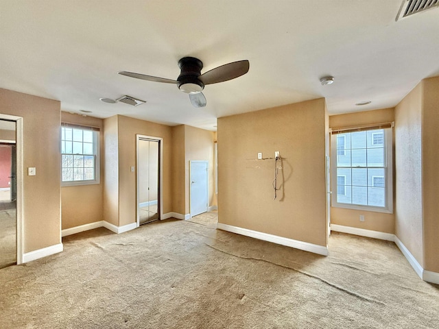 unfurnished living room featuring carpet flooring and ceiling fan