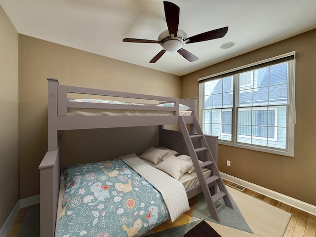 bedroom with wood-type flooring and ceiling fan