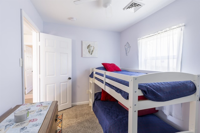 bedroom with baseboards, carpet, visible vents, and a ceiling fan