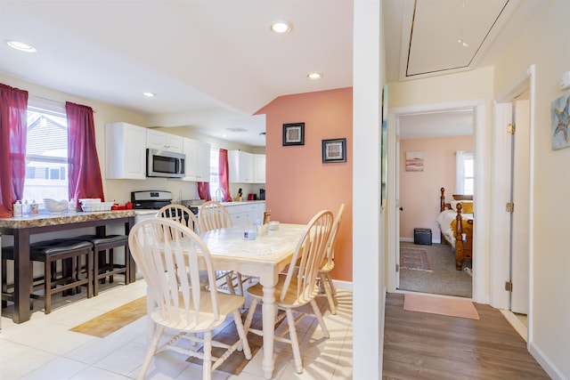 dining room with attic access, a wealth of natural light, and recessed lighting