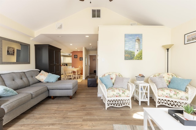 living room with light wood-style floors, visible vents, high vaulted ceiling, and recessed lighting