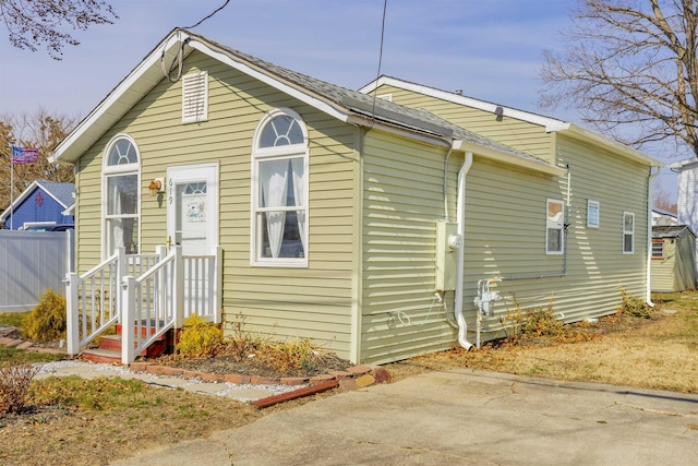 bungalow-style home with fence