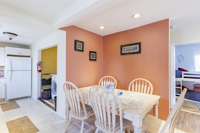 dining area featuring light tile patterned floors, washer / clothes dryer, and recessed lighting