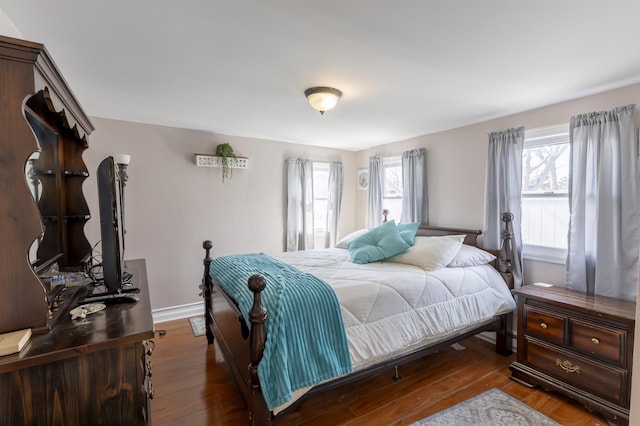 bedroom featuring baseboards and wood finished floors