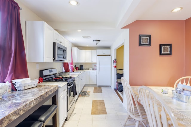 kitchen featuring appliances with stainless steel finishes, recessed lighting, light countertops, and light tile patterned flooring