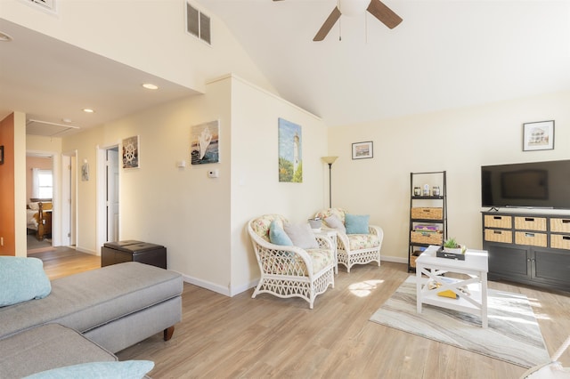 living area featuring visible vents, attic access, a ceiling fan, light wood-type flooring, and baseboards