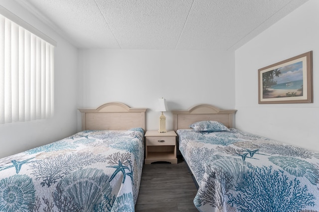 bedroom with dark wood-type flooring and a textured ceiling