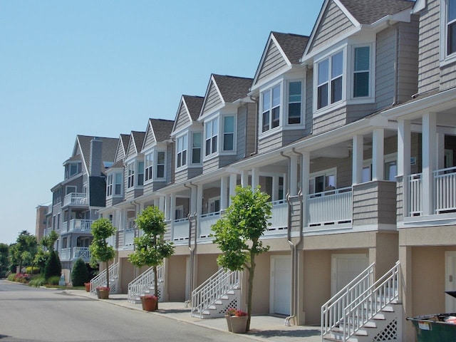 view of building exterior featuring a residential view and stairs