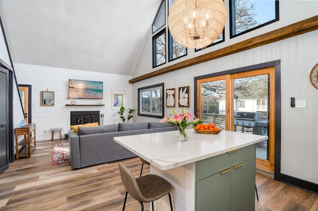512 Robin Rd, Villas, NJ 08251 - kitchen featuring green cabinetry, high vaulted ceiling, wood finished floors, a breakfast bar, and a center island