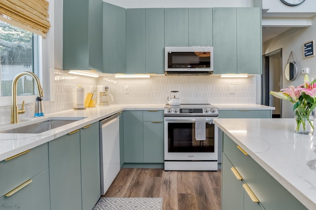 512 Robin Rd, Villas, NJ 08251 - kitchen featuring white appliances, a sink, dark wood-style flooring, light stone counters, and backsplash