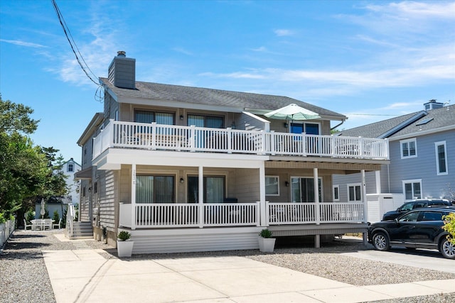 view of front of house with a porch and a balcony