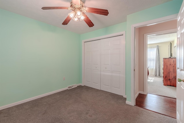 unfurnished bedroom with visible vents, carpet floors, and a closet