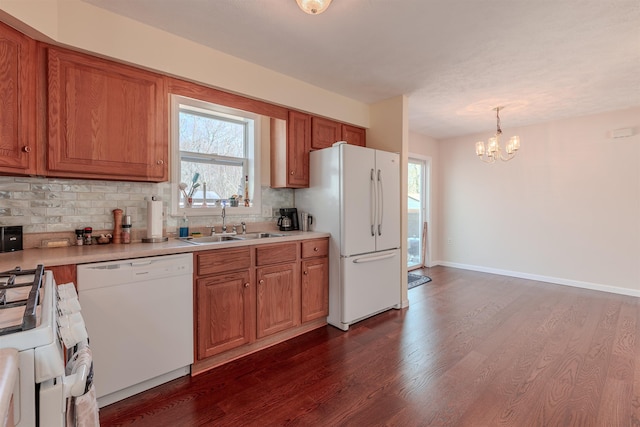 kitchen featuring white appliances, light countertops, dark wood-style flooring, and backsplash