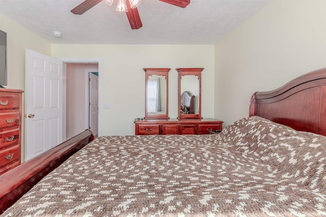 bedroom featuring a textured ceiling and a ceiling fan