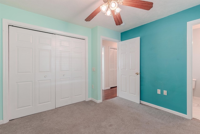 unfurnished bedroom featuring a ceiling fan, carpet, a closet, and baseboards