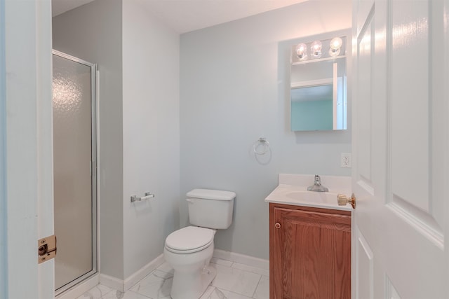 bathroom featuring vanity, a shower stall, baseboards, and marble finish floor