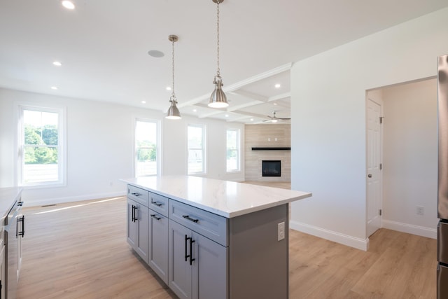 kitchen with light wood finished floors, baseboards, and gray cabinetry