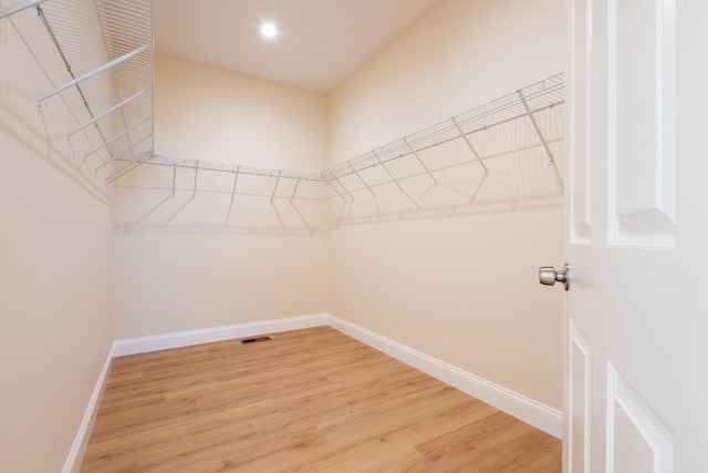 spacious closet featuring visible vents and light wood-style floors