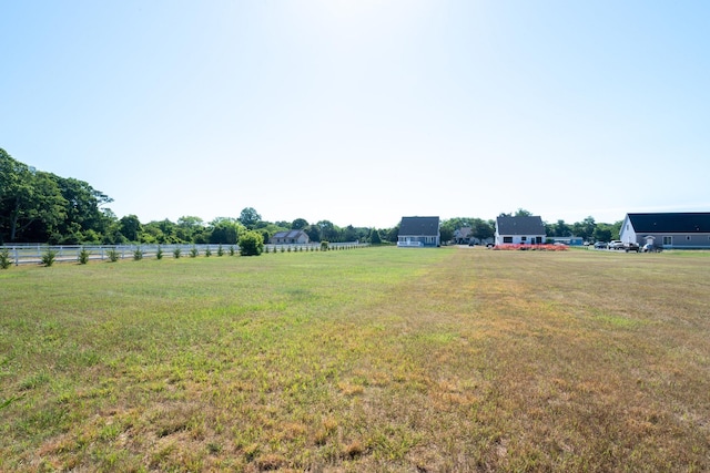 view of yard featuring fence and a rural view