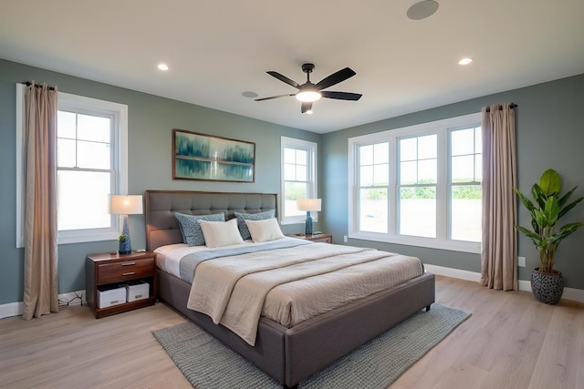 bedroom with light wood-style floors, recessed lighting, and baseboards